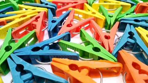Multi color plastic laundry clips rotating background, Clothes pins or pegs Stock Footage 306142618