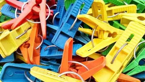 Multi color plastic laundry clips rotating background, Clothes pins or pegs Stock Footage 306276963