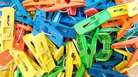 Multi color plastic laundry clips rotating background, Clothes pins or pegs Stock Footage 306276977
