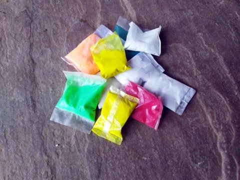 Multi color sand in plastic pouch on stone background Stock Photos