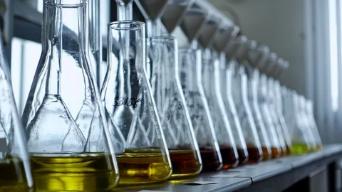 Multi Color Substances in Glass Flasks in the Laboratory, Close Up, Panoramic Stock Footage