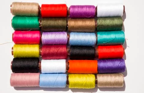 Multi-color thread coils on white background. Stock Photos