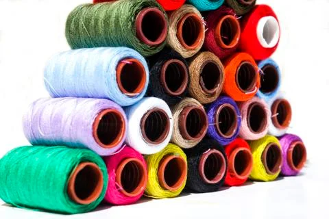 Multi-color thread coils on white background. Stock Photos