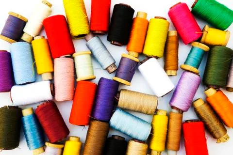Multi-color thread coils on white background. Stock Photos