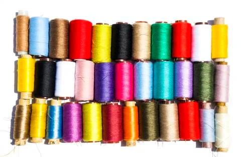 Multi-color thread coils on white background. 스톡 사진