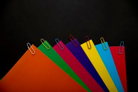 Multi-colored abstract geometric background. Colored sheets of paper on a bla Stock Photos