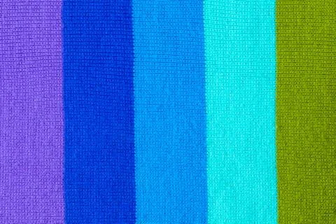 Multi colored background. knitted wool fabric texture with stripes Stock Photos
