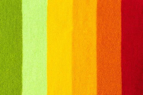 Multi colored background. knitted wool fabric texture with stripes Stock Photos