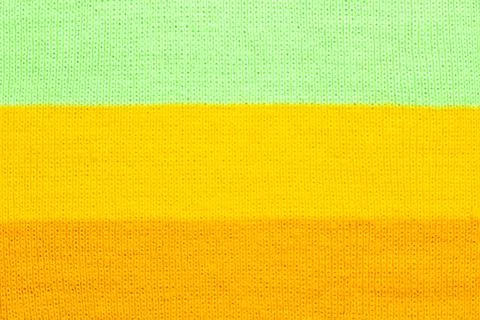 Multi colored background. knitted wool fabric texture with stripes Stock Photos