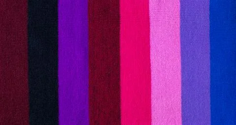 Multi colored background. knitted wool fabric texture with stripes Stock Photos