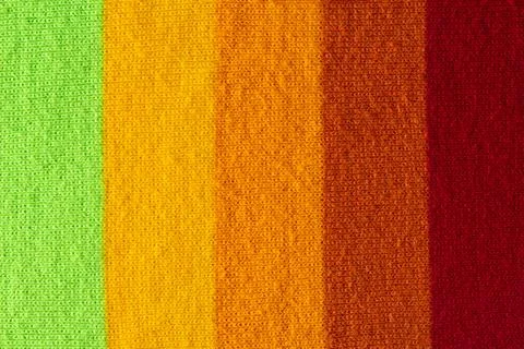 Multi colored background. knitted wool fabric texture with stripes Stock Photos