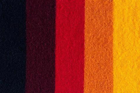 Multi colored background. knitted wool fabric texture with stripes Stock Photos