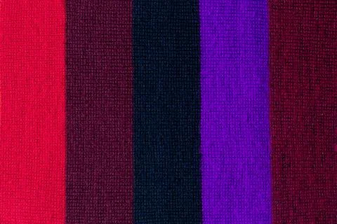 Multi colored background. knitted wool fabric texture with stripes Stock Photos