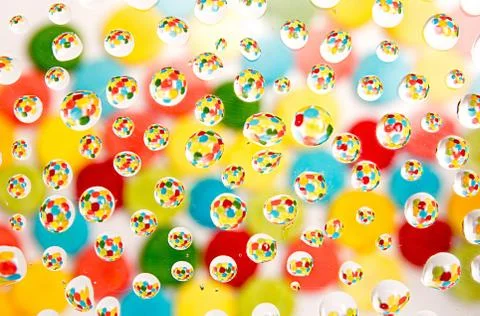 Multi-colored background with reflection in water drops Foto stock