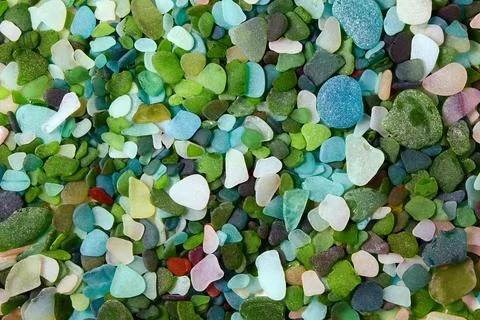 Multi-colored background from sea-polished glass shards of bottles. Glass beach Stock Photos