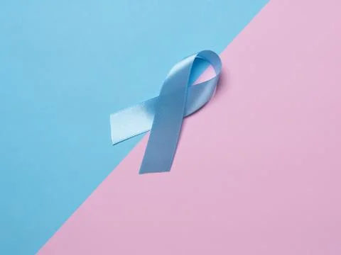 On multi-colored backgrounds pink and blue satin ribbon symbol of prostate ca Stock Photos