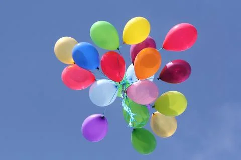 Multi colored balloons in blue sky Stock Photos