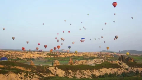  Multi-colored balloons fly over rocks. Cappadocia Stock Footage 304817838