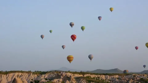  Multi-colored balloons fly over rocks. Cappadocia Stock Footage 304817844