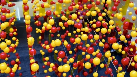 Multi-colored balls are stretched on ropes for decoration, swinging in the light Stock Footage 105987406