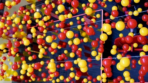 Multi-colored balls are stretched on ropes for decoration, swinging in the light Stock Footage 105987413