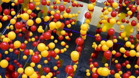 Multi-colored balls are stretched on ropes for decoration, swinging in the light Stock Footage 105987416