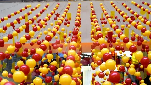 Multi-colored balls are stretched on ropes for decoration, swinging in the light Stock Footage 106054709