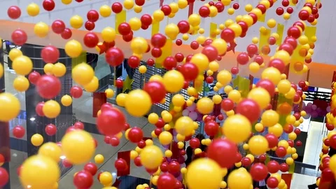 Multi-colored balls are stretched on ropes for decoration, swinging in the light Stock Footage 106054750