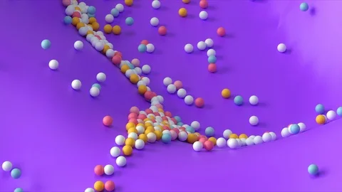 Multi-colored balls change color, roll along a smoothly moving purple texture Stock Footage 126569475