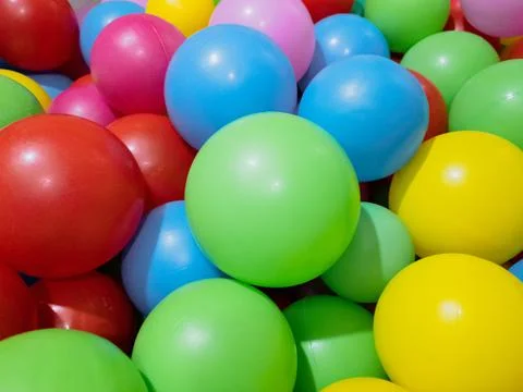 Multi-colored balls for a dry pool for children to play in the house and Stock Photos