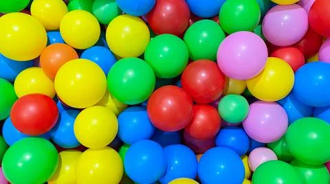 Multi-colored balls for a dry pool for children to play in the house and Stock Photos