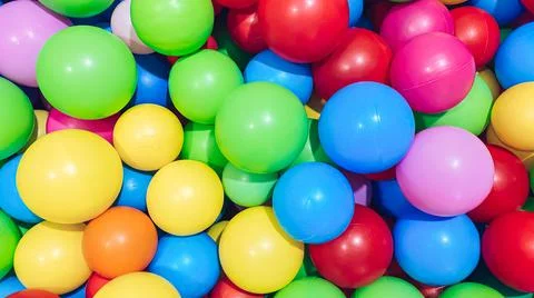 Multi-colored balls for a dry pool for children to play in the house and Stock Photos