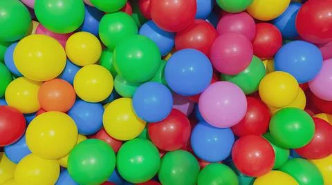 Multi-colored balls for a dry pool for children to play in the house and Stock Photos