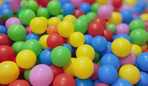 Multi-colored balls for a dry pool for children to play in the house and Stock Photos