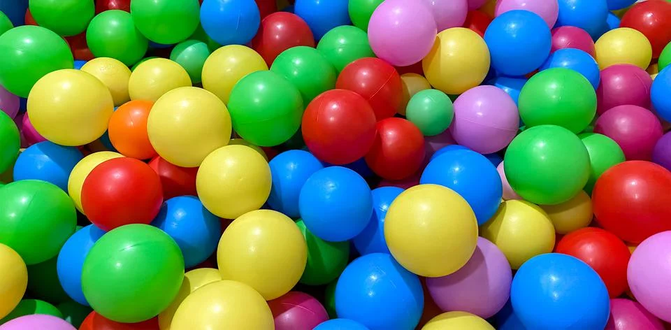 Multi-colored balls for a dry pool for children to play in the house and Stock Photos