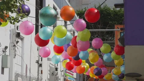 Multi colored balls sway in the wind Stock Footage 208954637