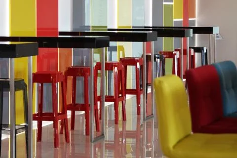 Multi-colored bar stools in a colorful interior Foto stock