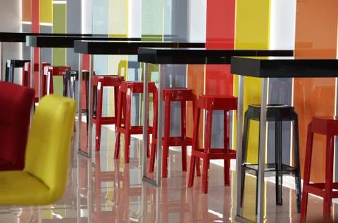 Multi-colored bar stools in a colorful interior Stock Photos