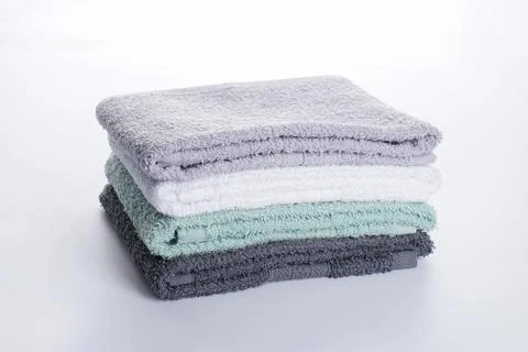 Multi-colored bath towels on a white background. Bath accessories. Hygiene pr Stock Photos