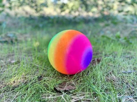 Multi colored beach ball on playground Stock Photos