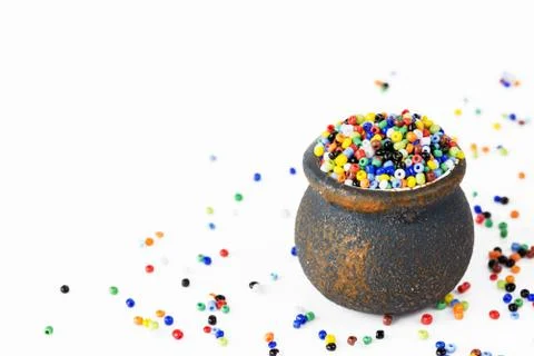 Multi-colored beads in a small ceramic pot Stock Photos