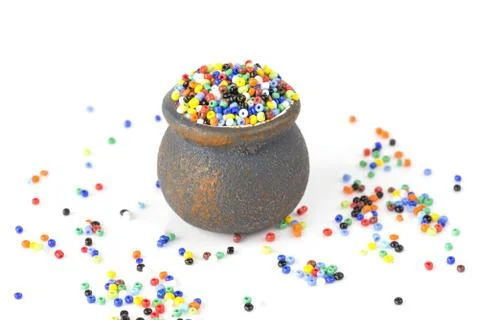 Multi-colored beads in a small ceramic pot Stock Photos