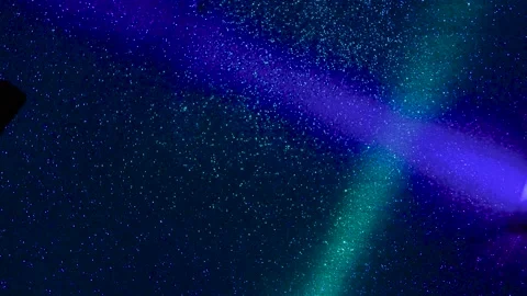 Multi-colored beams of light blink on a dark background. Stock Footage 195699689