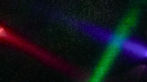 Multi-colored beams of light blink on a dark background. Stock Footage 195699896