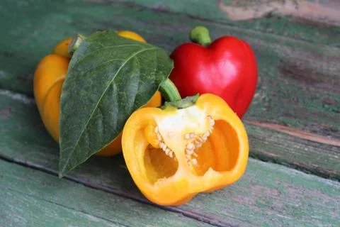 Multi-colored bell peppers on the background of boards Stock Photos