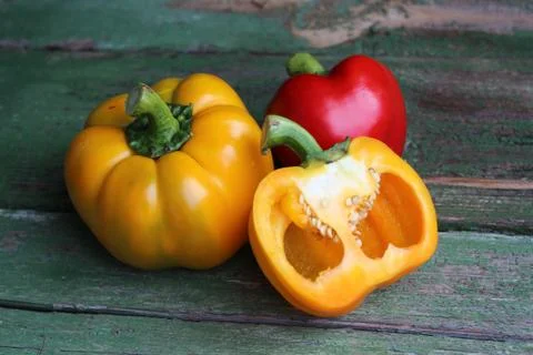 Multi-colored bell peppers on the background of boards Stock Photos