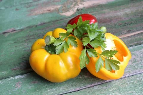 Multi-colored bell peppers on the background of boards Stock Photos