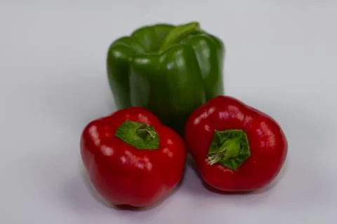 Multi-colored bell peppers lie on a white background for food shooting. Fresh Stock Photos