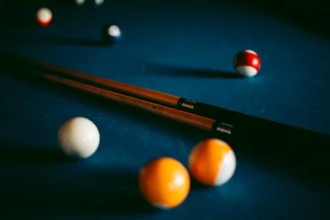 Multi-colored billiard balls on a blue table Stock Photos