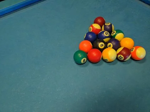 Multi-colored billiard balls on a pool table Foto stock